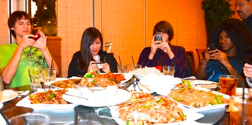 people taking pictures of food